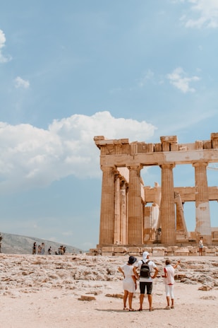 A group of tourists exploring the ancient ruins of Mohenjo-Daro under clear blue skies.