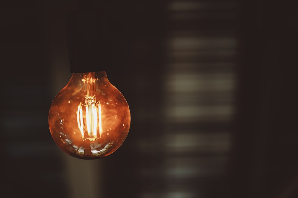 orange light bulb turned on in dim light photo – Free Lightbulb Image on  Unsplash