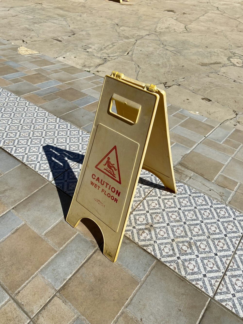 brown and white caution wet floor sign