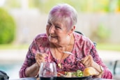 woman in purple and pink floral long sleeve shirt sitting on chair