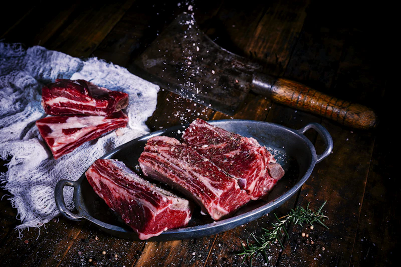 Aged beef cuts arranged on dark wood