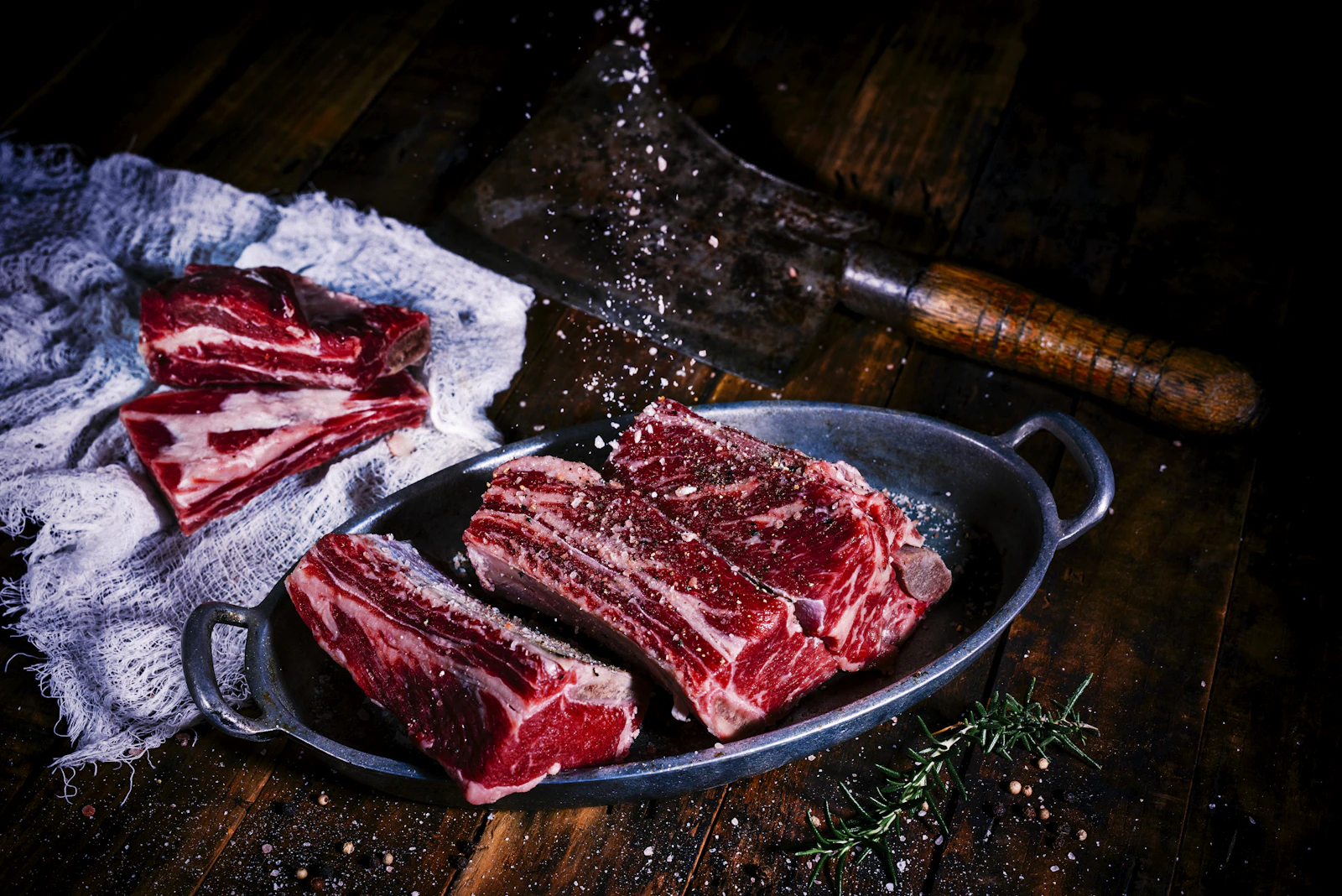 Aged beef cuts arranged on dark wood