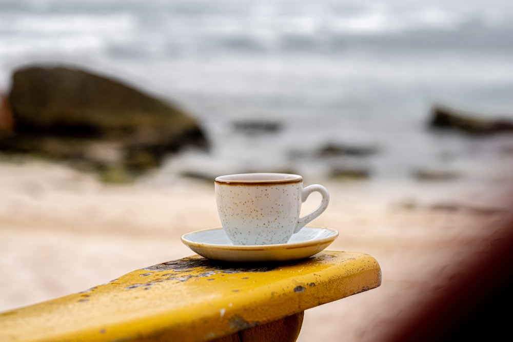 white ceramic mug on yellow table