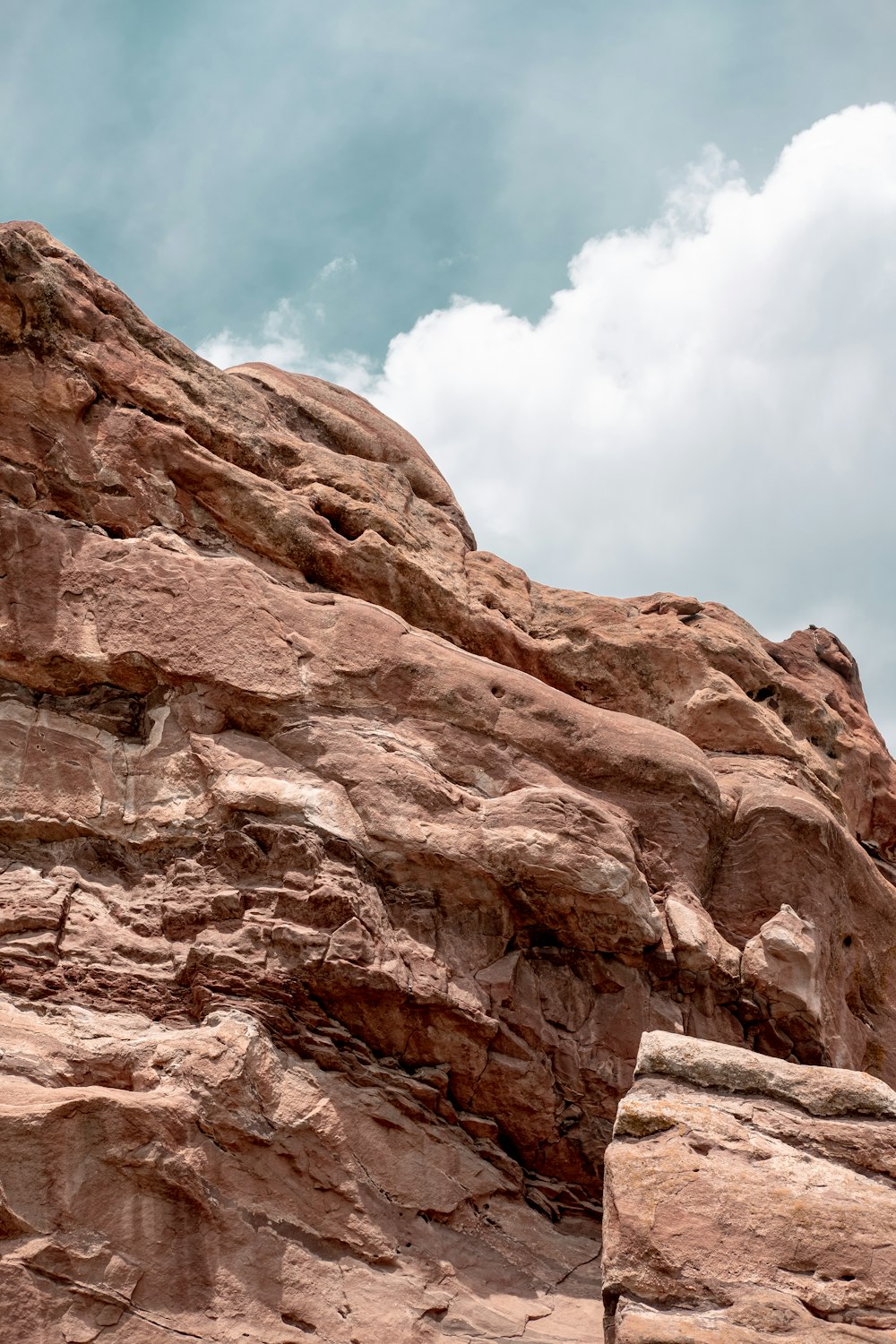 brown rocky mountain under blue sky and white clouds during daytime