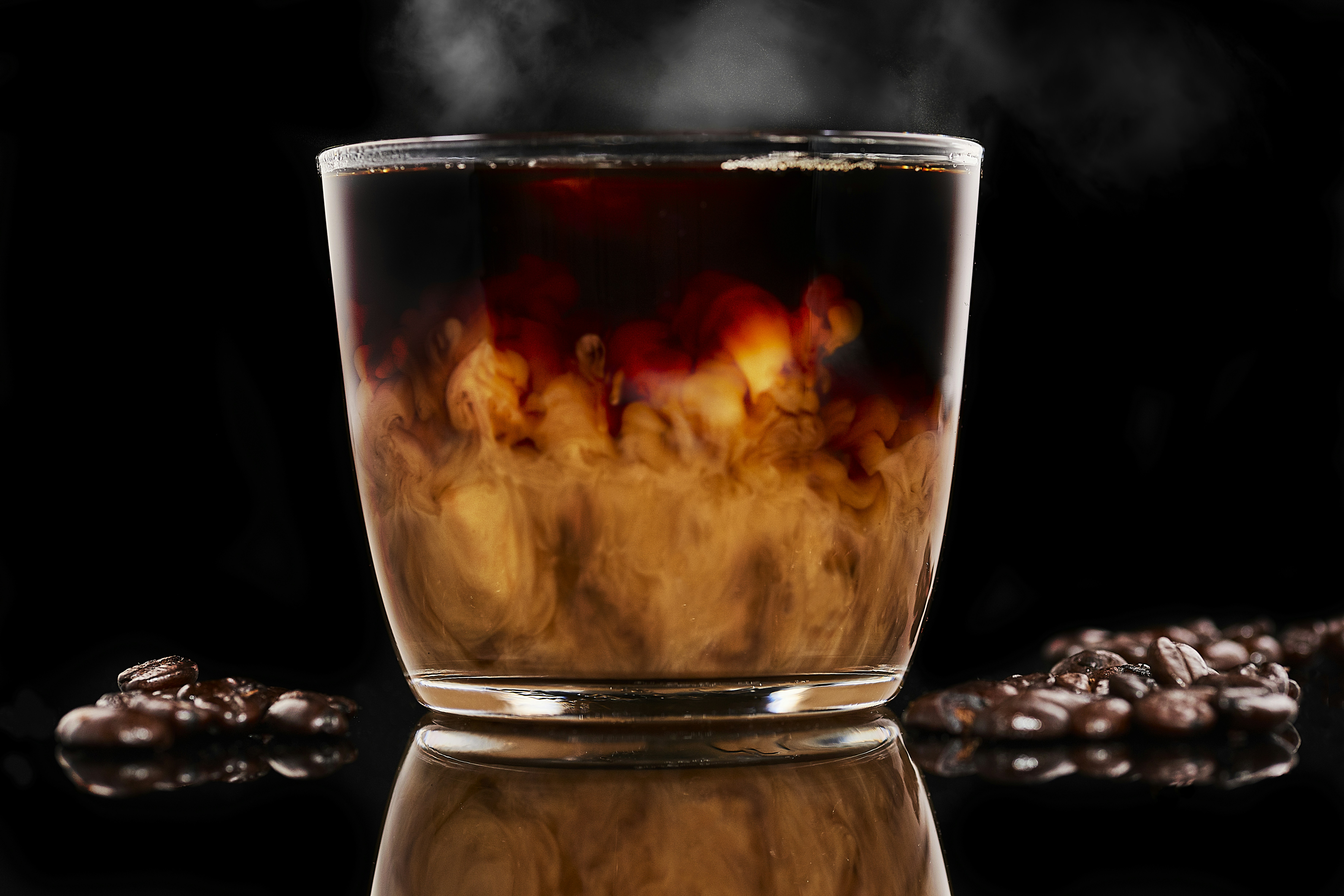 clear drinking glass with brown liquid inside