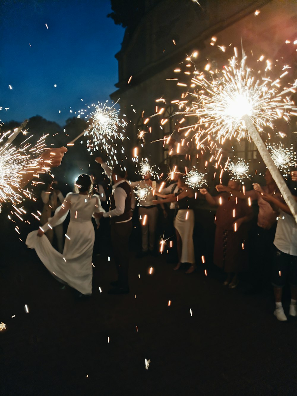 people standing and watching fireworks display during night time