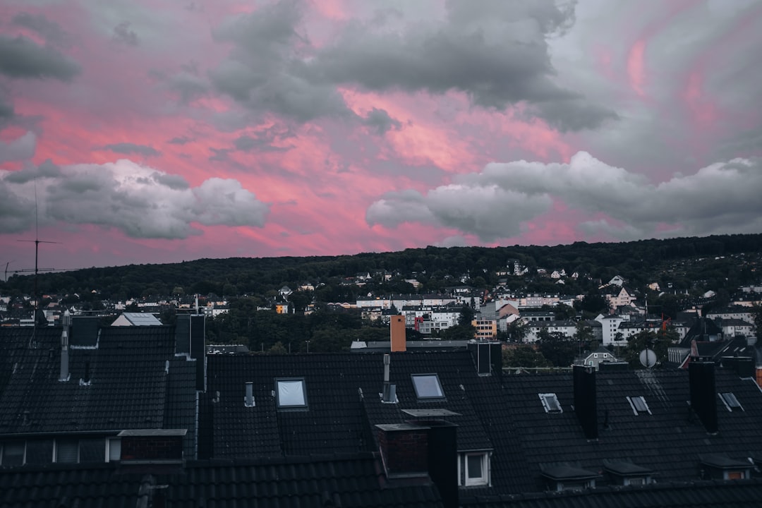 city with high rise buildings under white clouds during daytime