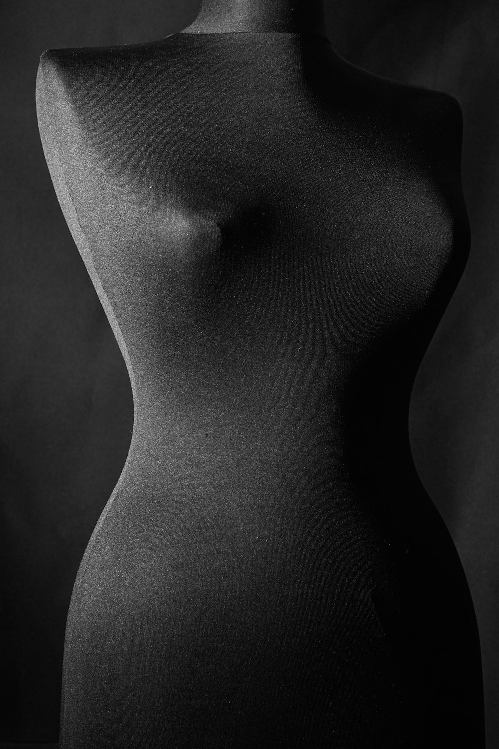 womans breast in grayscale