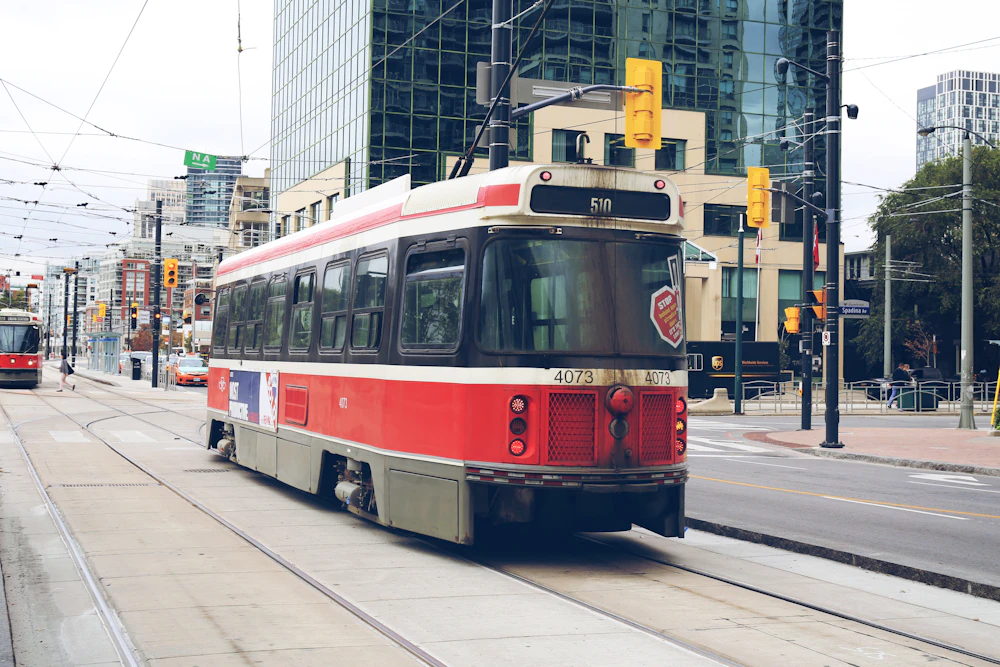 A classic red and white TTC streetcar in downtown Toronto