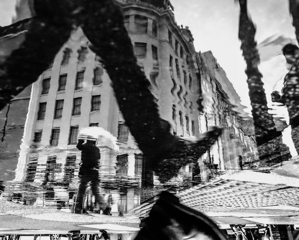 grayscale photo of person walking on street