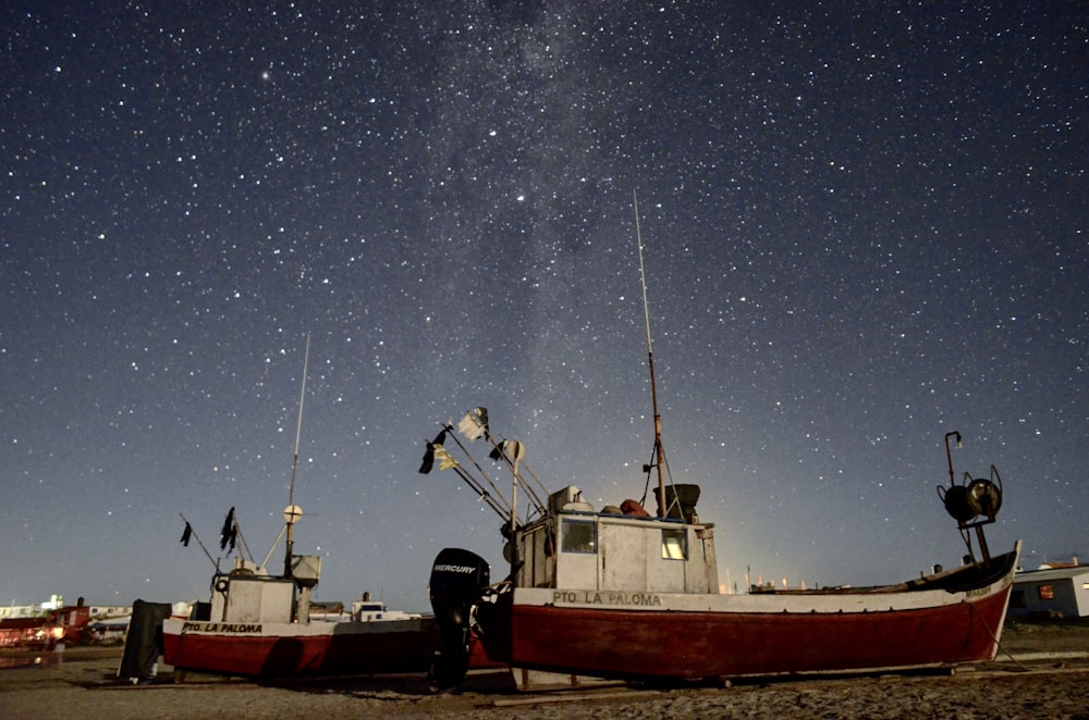 red and white boat on sea during night time