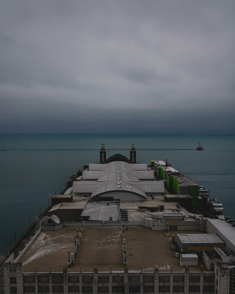 gray concrete building near sea under white sky during daytime