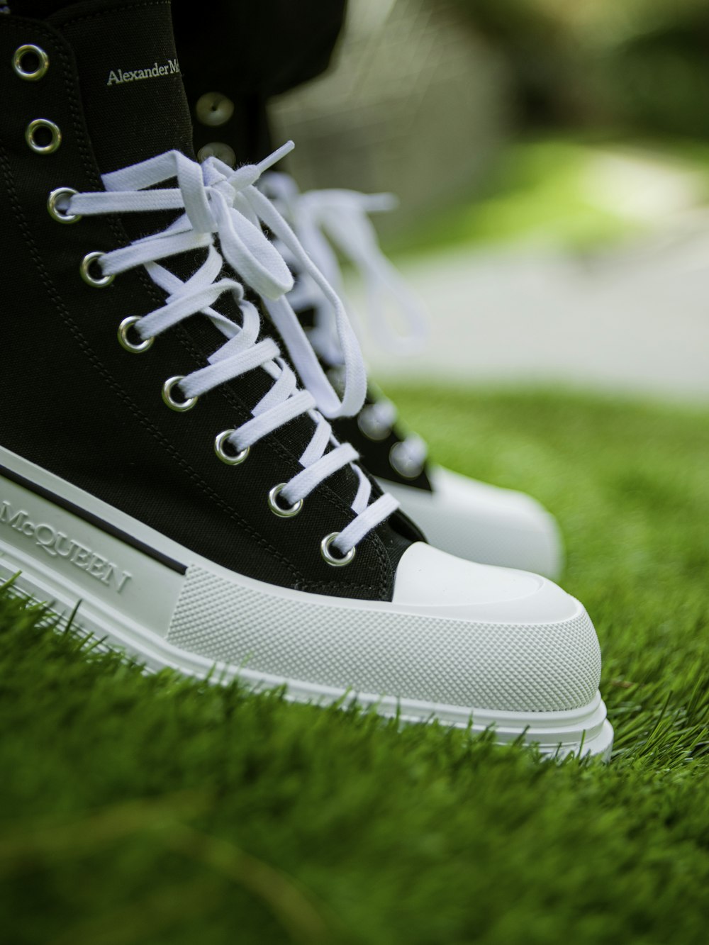 black and white nike athletic shoes on green grass during daytime