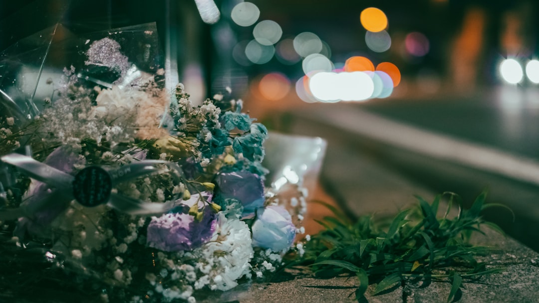 white and purple flowers on brown wooden table