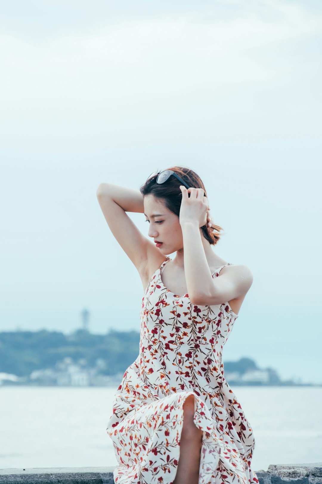 woman in white and red floral tank top wearing black sunglasses