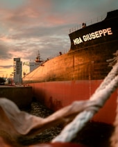 black ship on dock during sunset