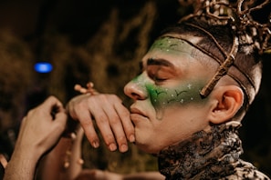 Woman with green face paint participating in acting classes