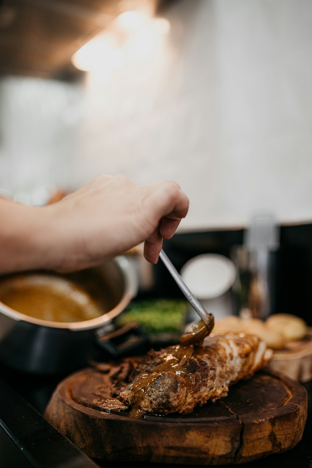 persona sosteniendo una cuchara de plata y carne dorada