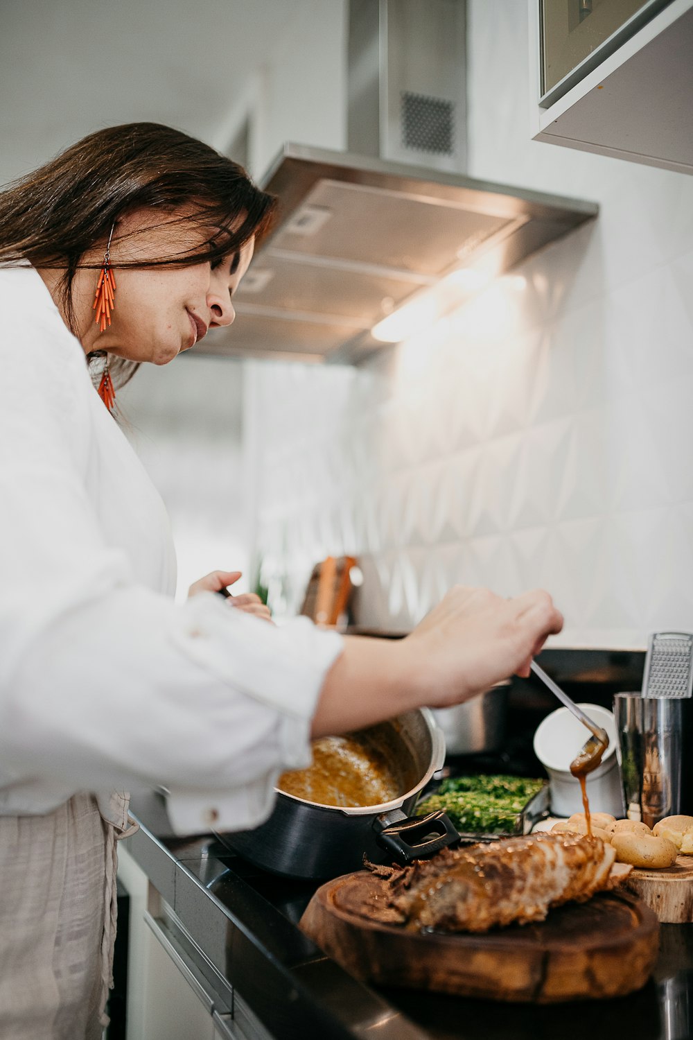 woman in white long sleeve shirt holding silver fork