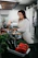 woman in white long sleeve shirt holding green vegetable