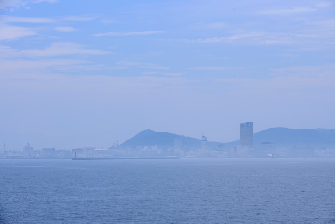 city skyline across the sea during daytime