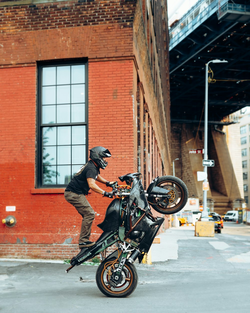 man in black jacket riding motorcycle on road during daytime