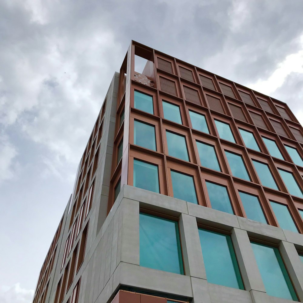 brown concrete building under white clouds during daytime