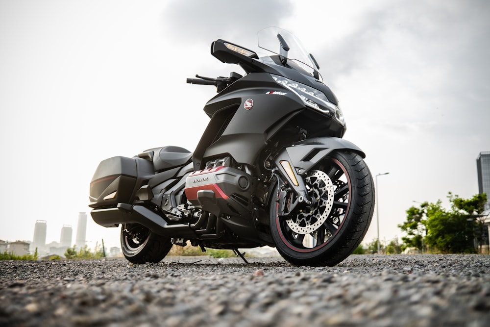 black and gray sports bike on brown field during daytime