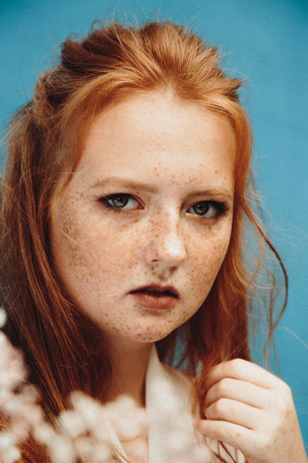 woman with brown hair and white shirt