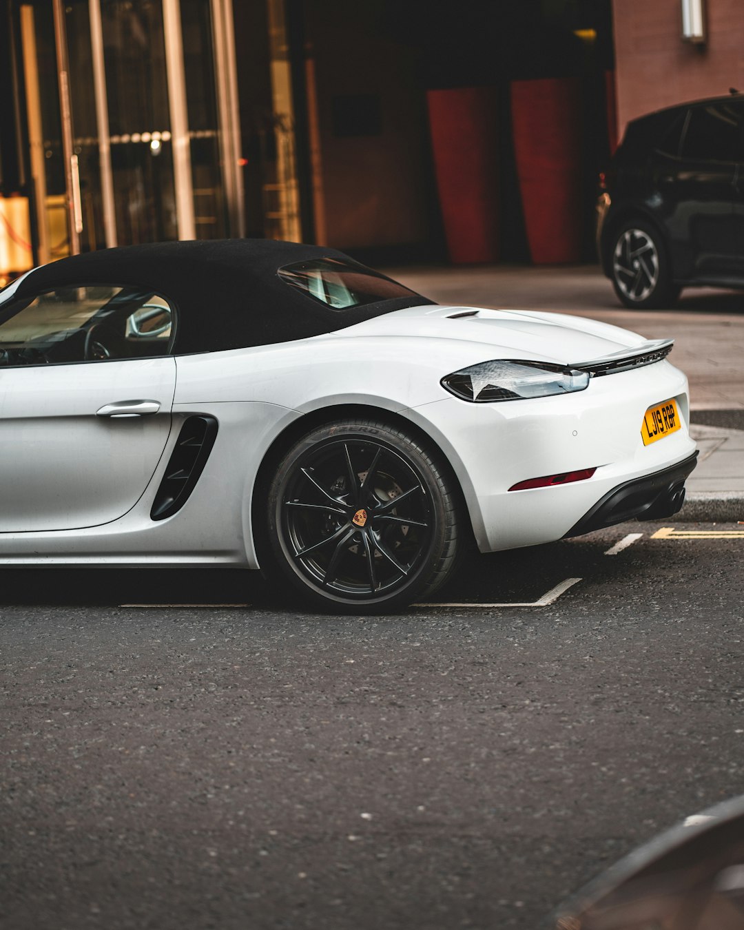 white porsche 911 parked on street during daytime