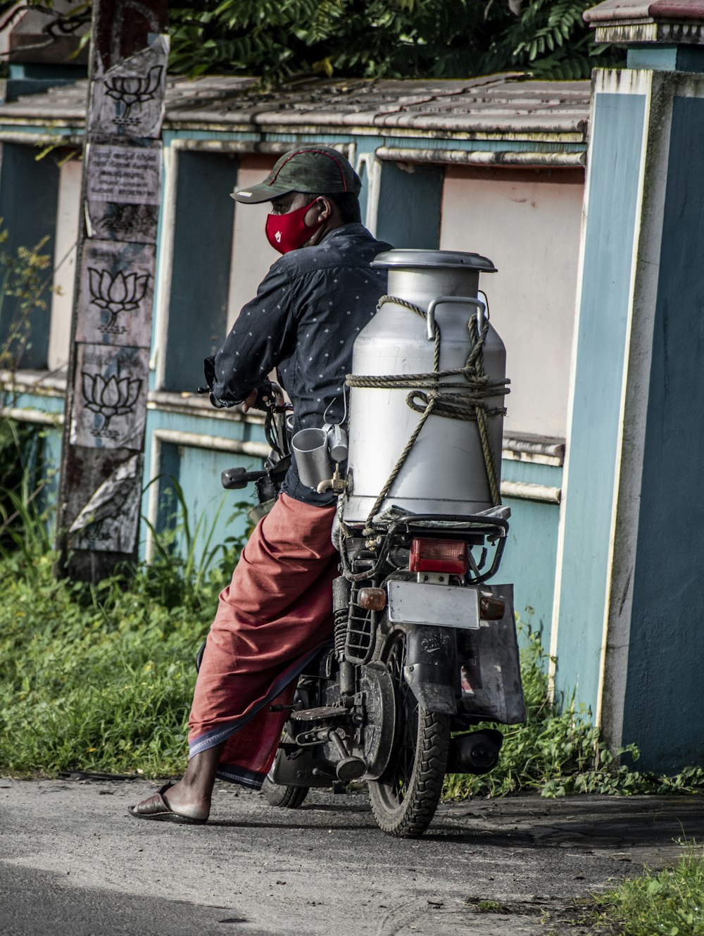 man in black leather jacket and red pants riding black motorcycle