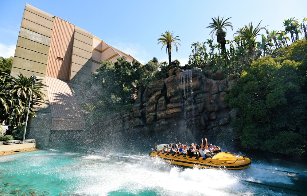 people riding yellow and black inflatable boat on water during daytime