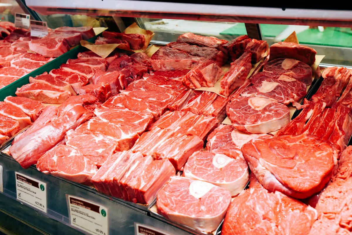 Beef cuts laid out in a butcher case with price tags