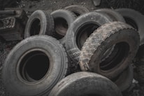 Close-up of new and used tires stacked neatly in the workshop.