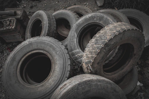 Stack of new and used tires neatly arranged in the service area.