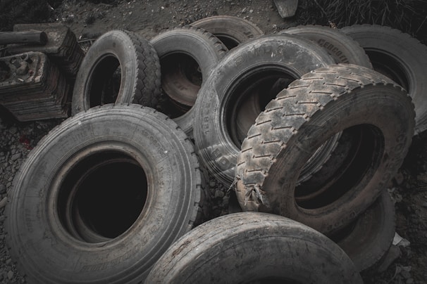 Stacks of used tires and wheels organized for resale.