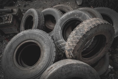 Close-up of new and used tires stacked neatly in the workshop.