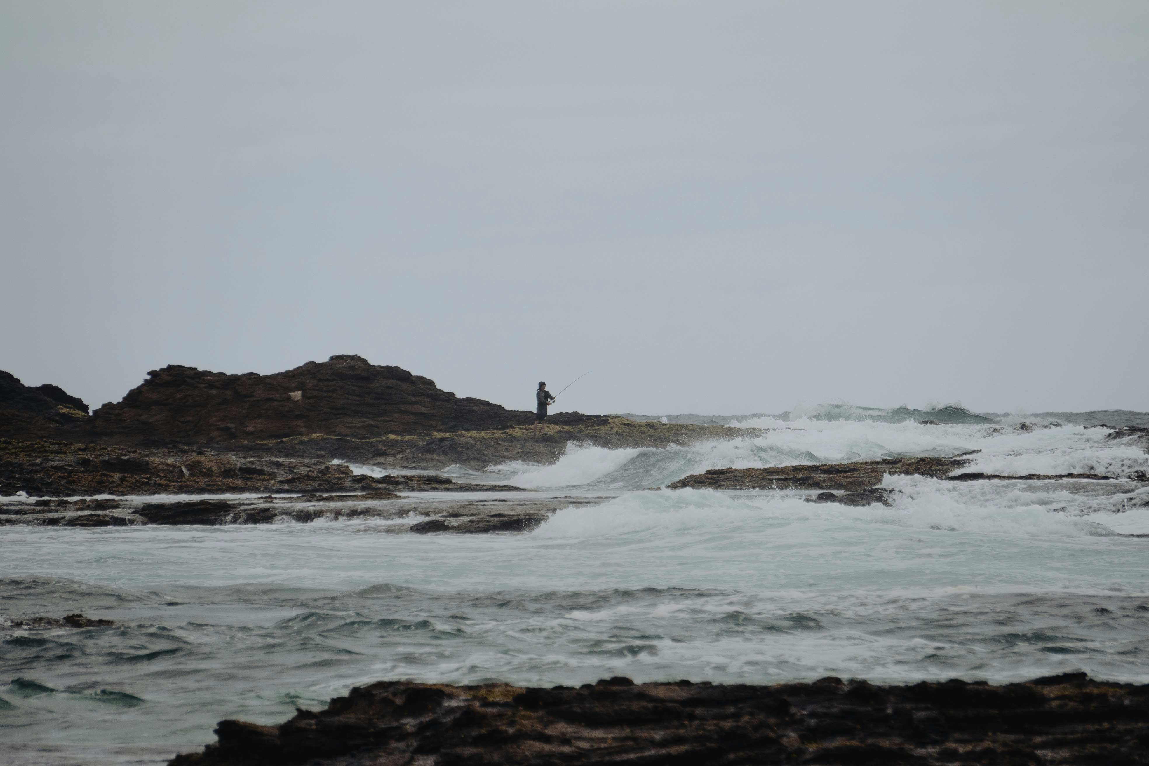 person surfing on sea waves during daytime