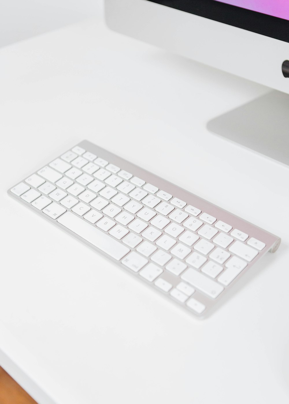 white apple keyboard on white table