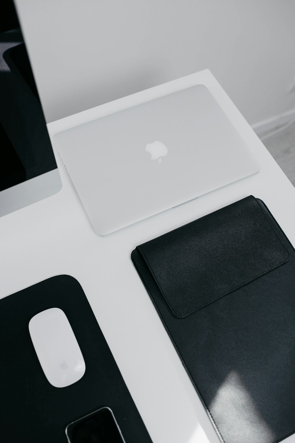 silver macbook on white table