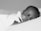 A peaceful close-up of a sleeping baby with eyes gently closed against a soft pillow. The baby appears serene and comfortable in this black and white photograph.