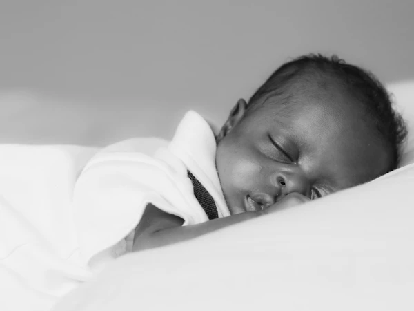 A newborn asleep in white