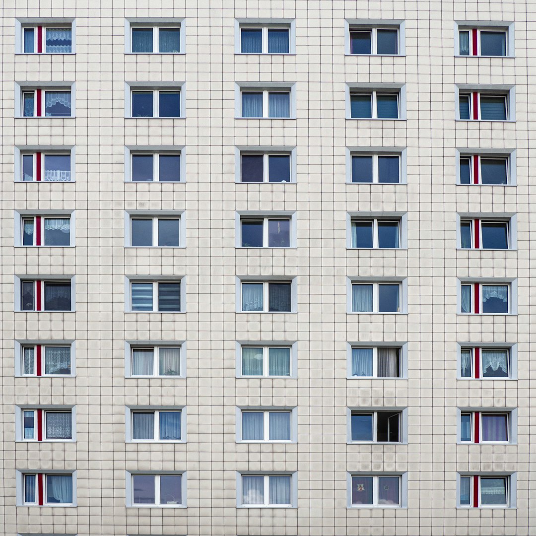 white concrete building with glass windows