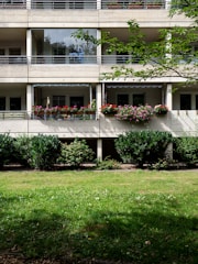 white concrete building with green grass lawn