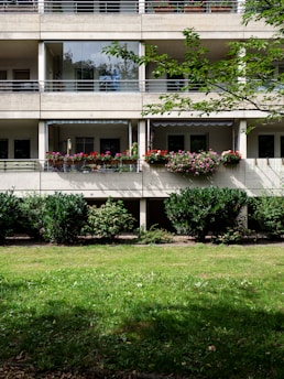 white concrete building with green grass lawn