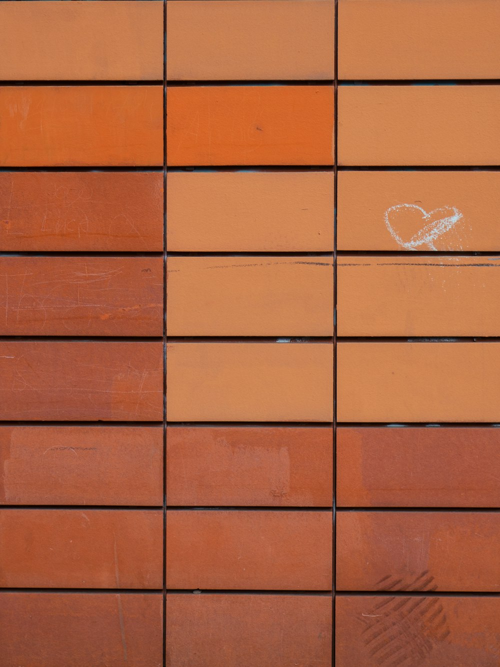 muro di mattoni marroni con stampa di cuori bianchi