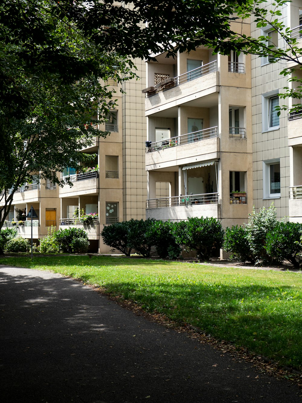 green grass field near brown concrete building during daytime