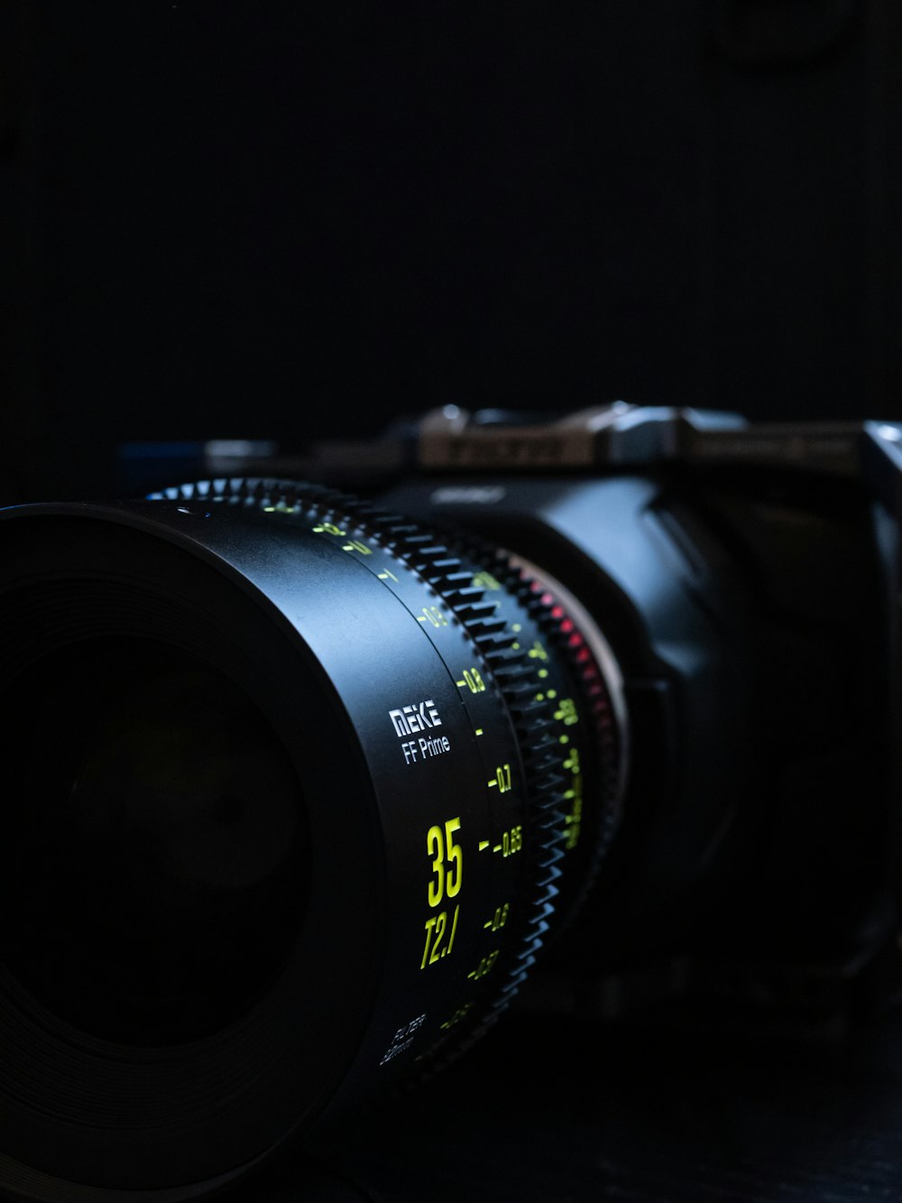 black camera lens on brown wooden table