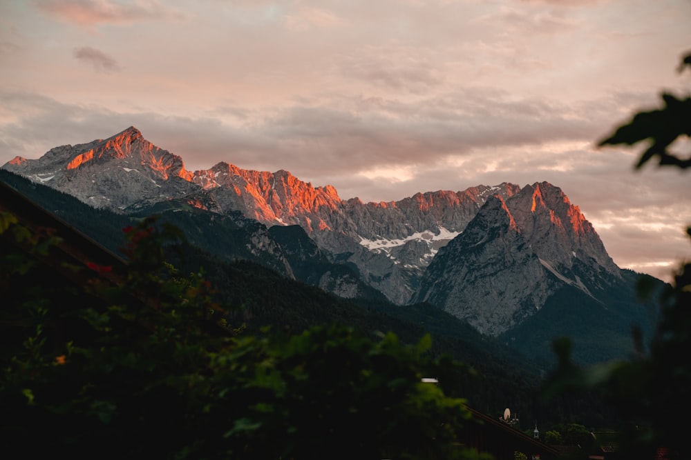 brown and white mountain under cloudy sky during daytime