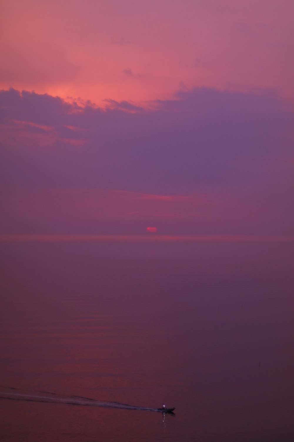 body of water under cloudy sky during sunset